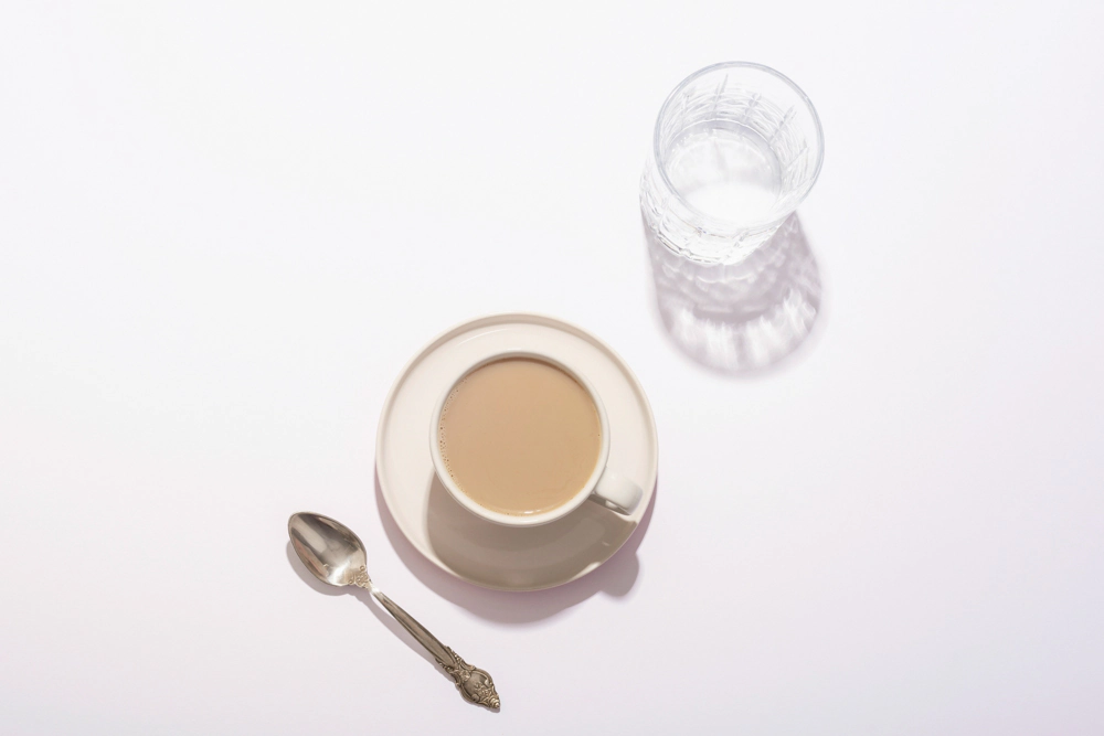 A cup of coffee and a glass of water showing what to drink on paleo
